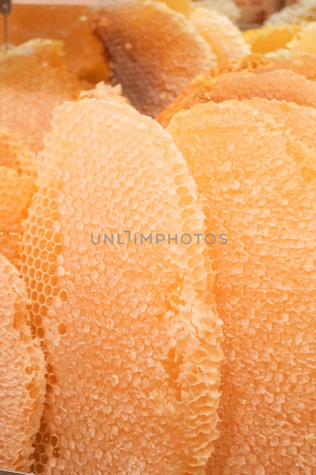 close up of fresh honey with comp in a jar .