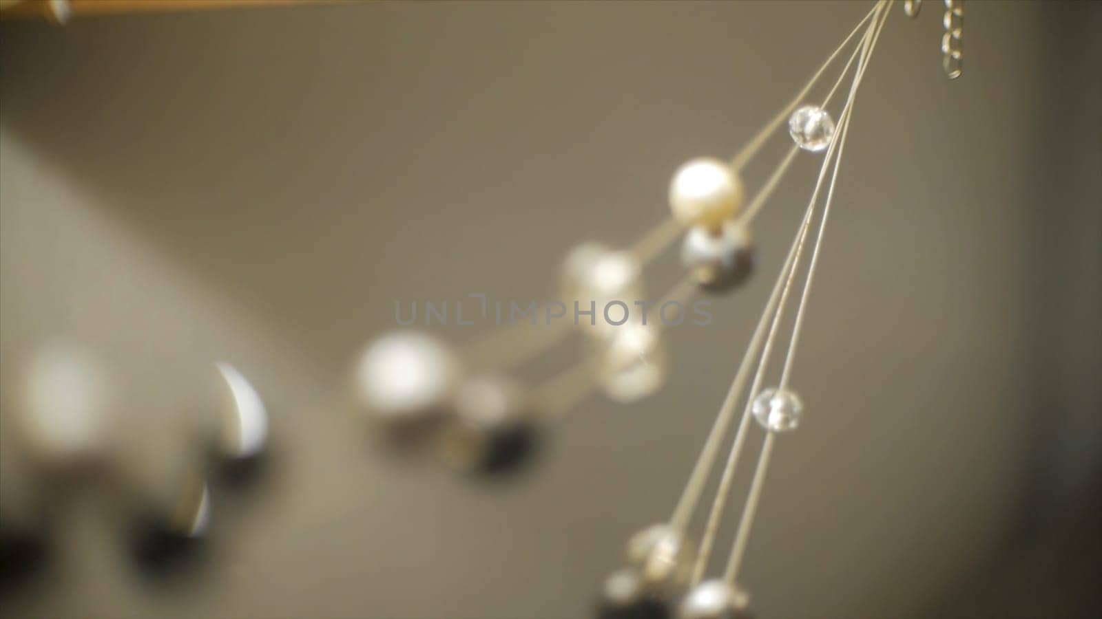 Close up view of costume jewellery or pendant, selective focus. Beautiful close up gold chain, pendant, precious stones, diamonds, costume jewelry, jewelry. Clip. necklace with gem.