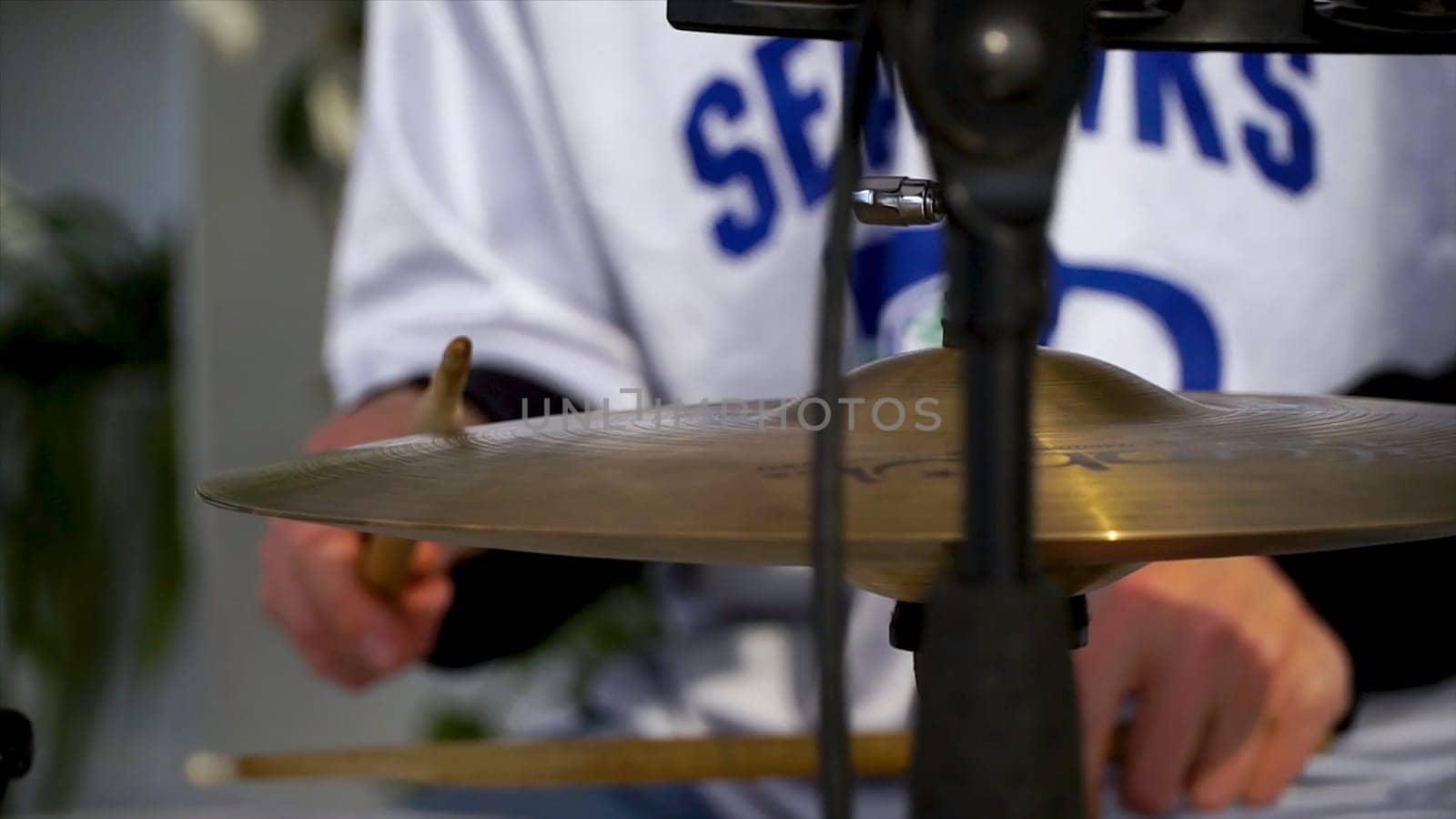 The drummer in action. Cose up process play on a musical instrument. Clip. A plate of the drum set. Close-up. Hand of drummer with sticks and drums, close-up.