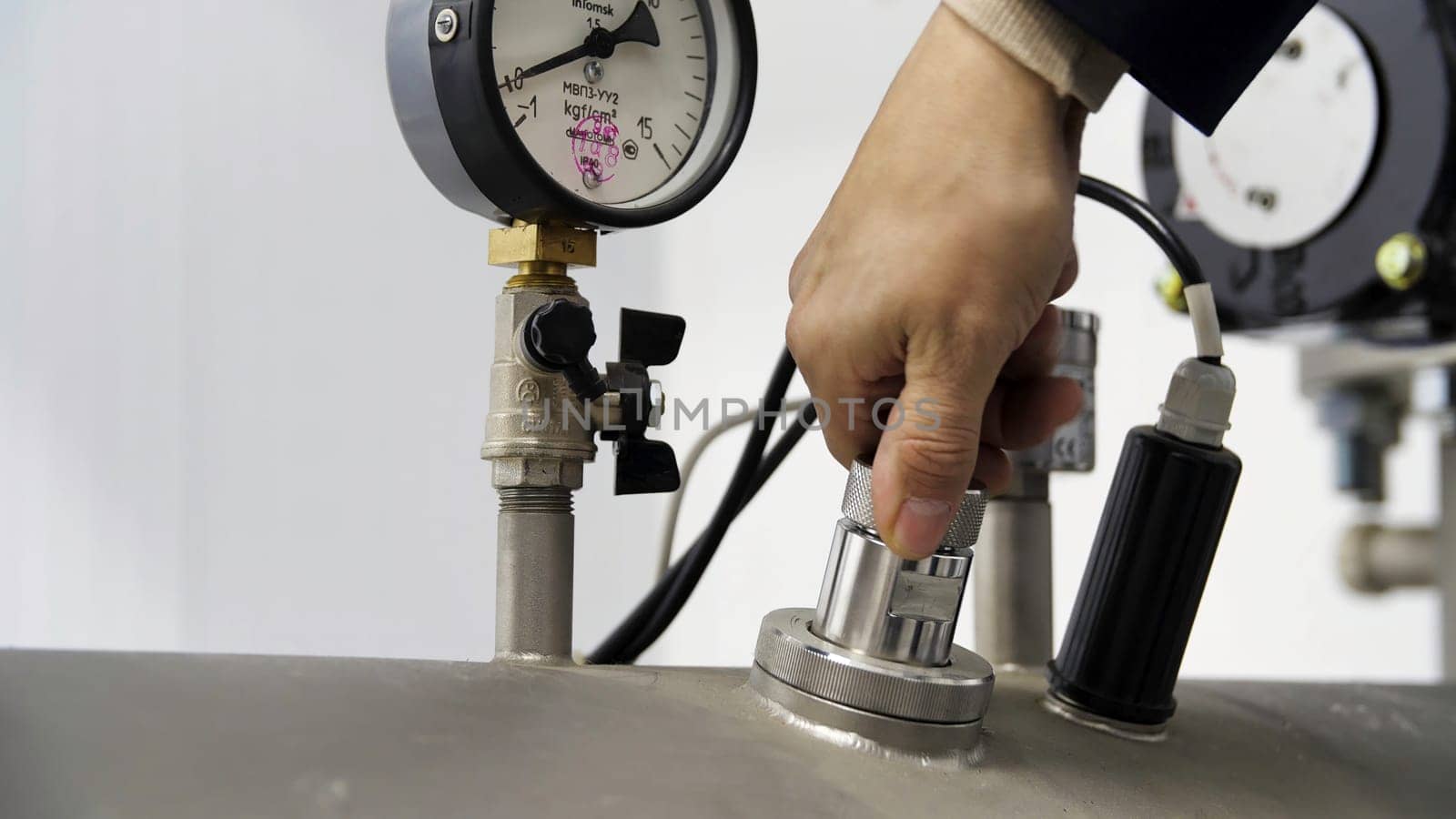 Close up of details of water filter at the plant. Professional equipment for the water purification, silvertanks and pipes, modern complex technological industrial background.