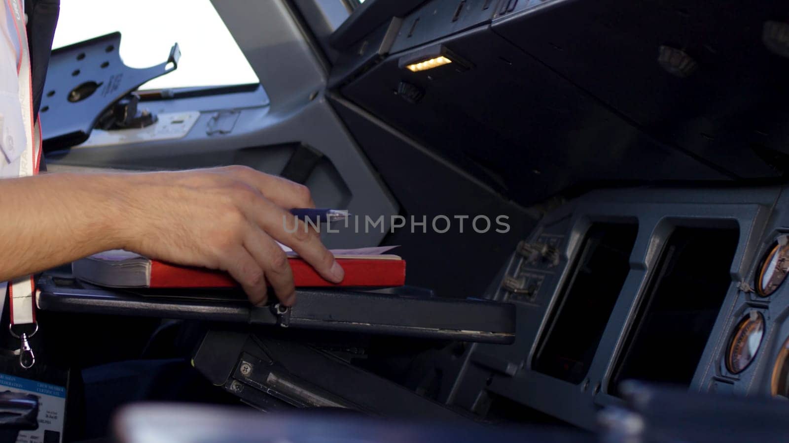 Rear view of pilot operating controls of corporate jet. the pilot checks all the systems. Rear view of pilot and copilot operating controls of corporate jet. Pilot and copilot in commercial plane