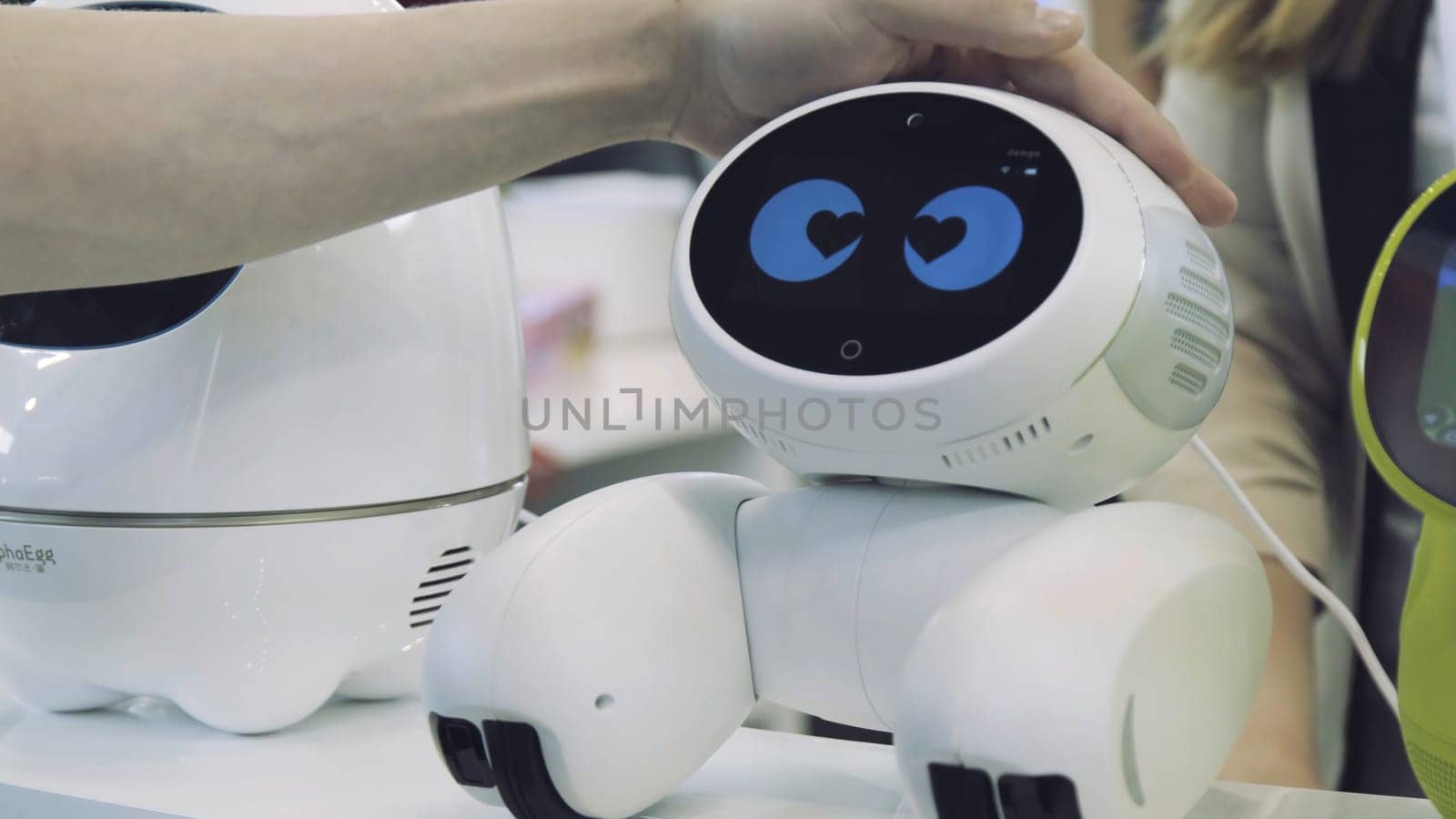 Hand of man touches the robot. Robot is happy with the touch of a human. Technology concept.