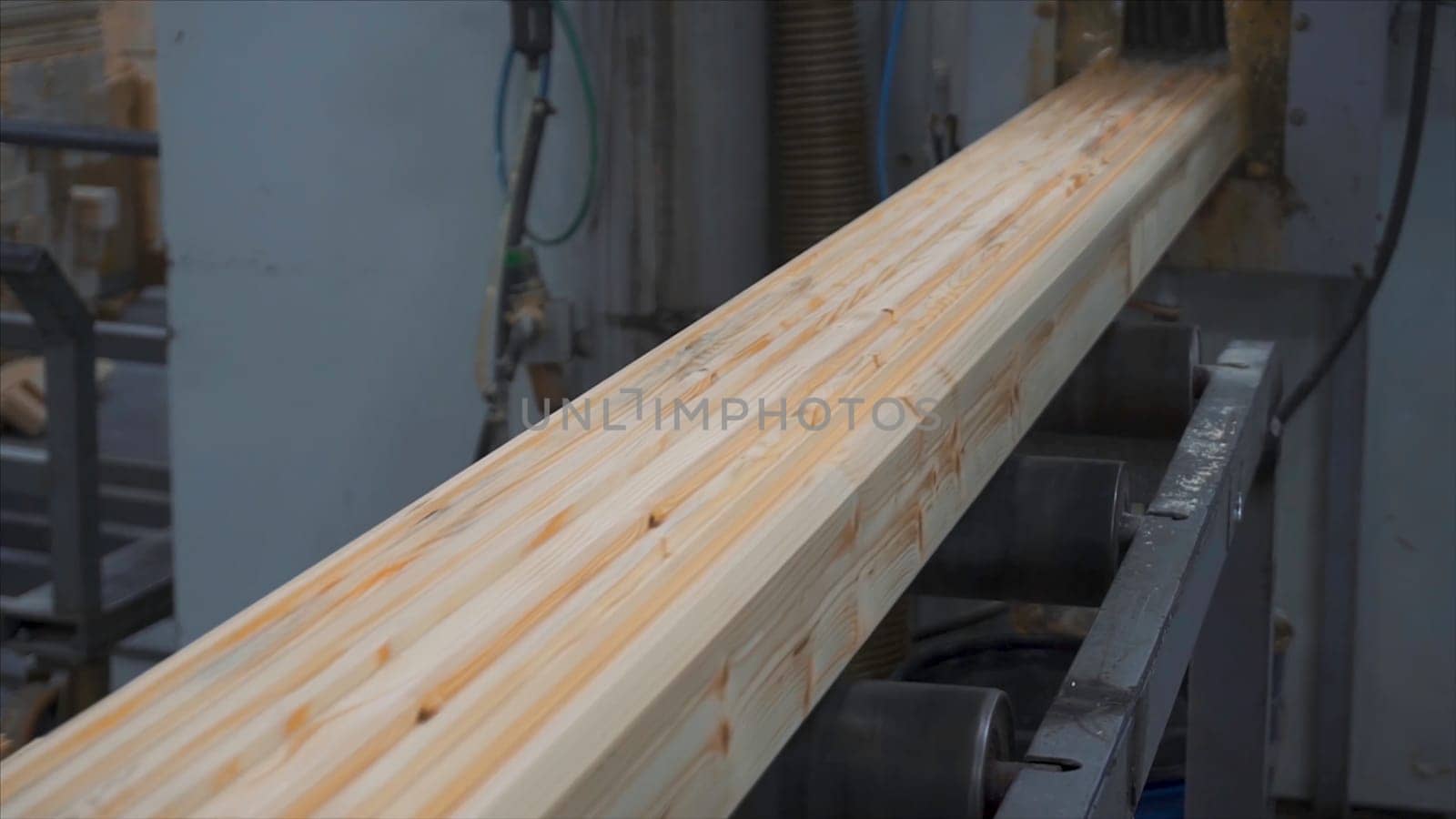 Construction wooden cottage. Measuring pine bars with the help of a corner tool outdoor closeup. Plant of construction of wooden bars. Bonding of wooden bars. Apply the adhesive to the bonding surfaces. Industrial construction