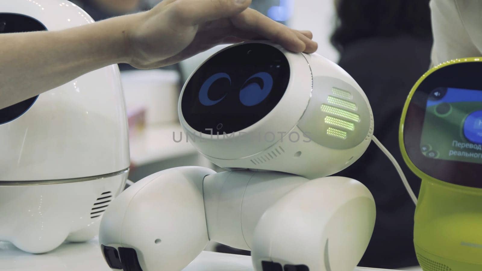 Hand of man touches the robot. Robot is happy with the touch of a human. Technology concept.