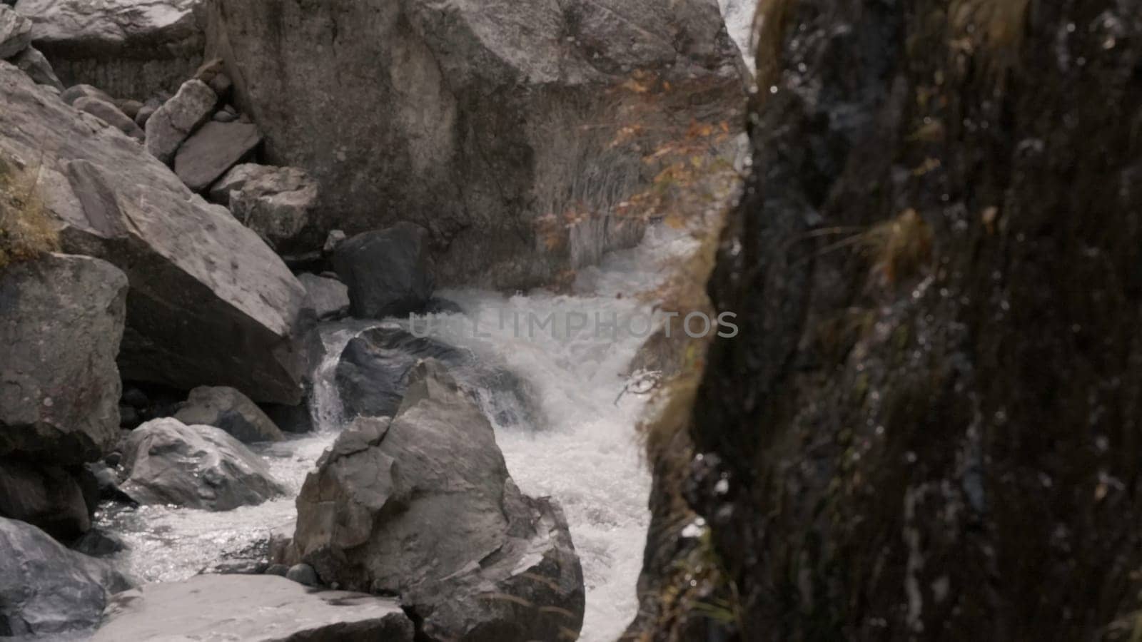 Slow-motion shooting of waterfall in rocks. Creative. Beautiful currents and cascades of waterfall among rocks. Cascading waterfall flow in rocks.