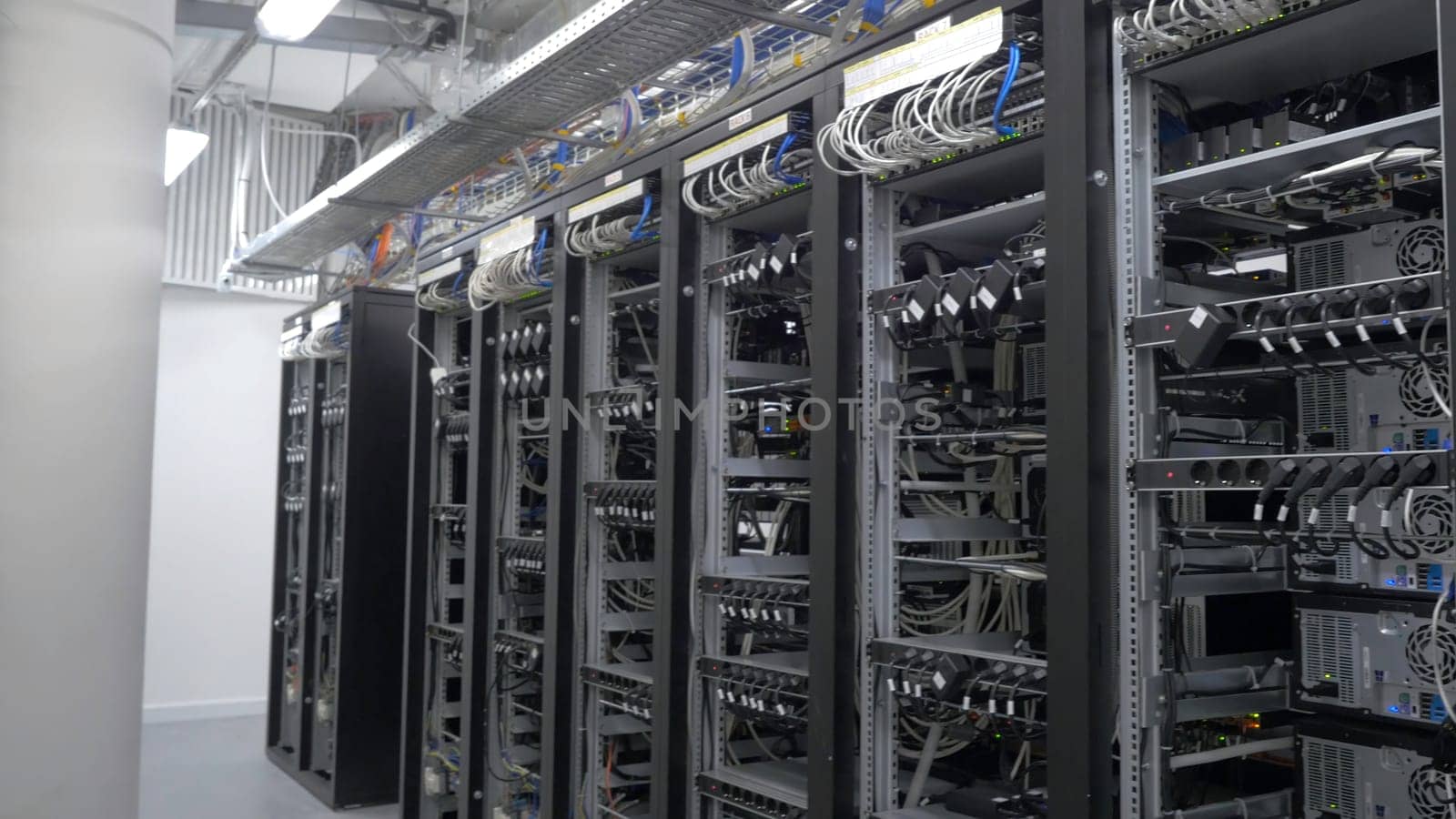 Row of bitcoin miners set up on the wired shelfs. Device for mining crypto currency. Mining cryptocurrency. Bitcoin farm. Machines for mining cryptocurrency, bitcoin. Electronic device at day 4K