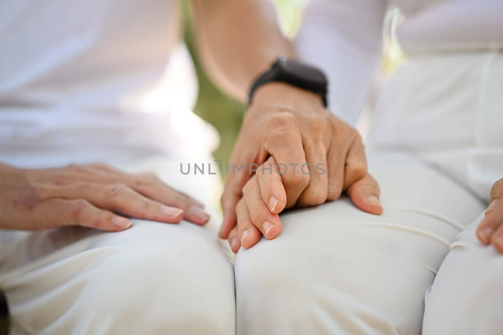 Closeup retired senior couple holding hands symbolizing supporting, empathy and understanding