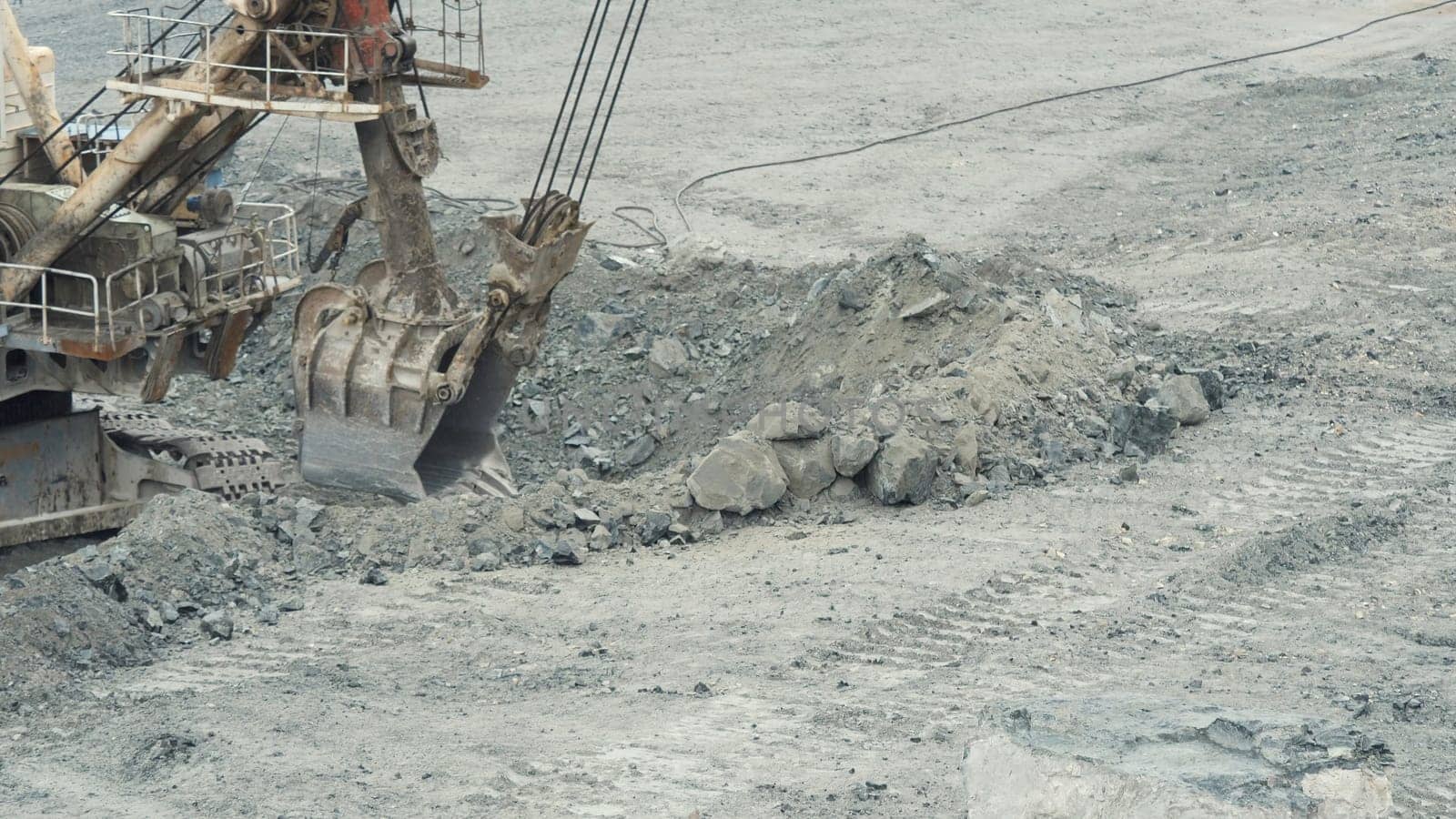 Close-up of mining excavator scooped up the ore with a bucket. Quarry mining equipment