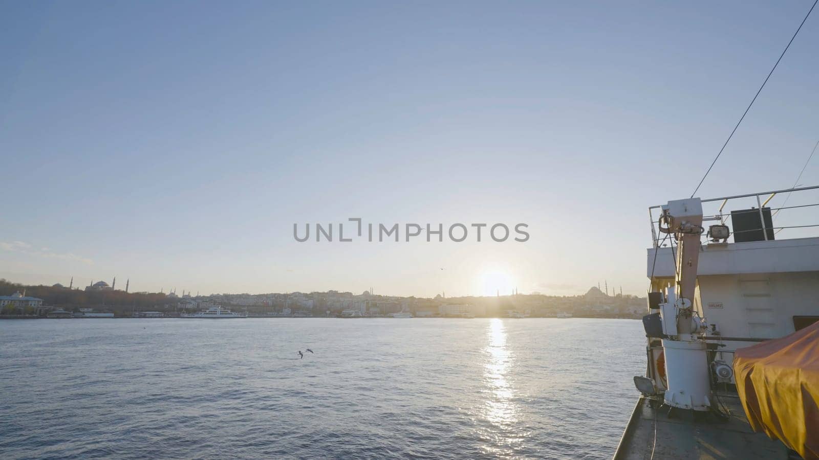 Timelapse of sailing on boat on sunny day. Action. View from side of boat on fast swim to shores of sea town. Boat sails through harbor at seaport on clear day.