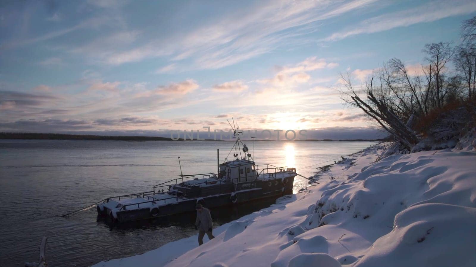 Timelapse of beautiful sky at dawn and boat on shore. Clip. Seascape of cloudy sky and dawn sun. Boat is standing on shore with view of sea dawn.
