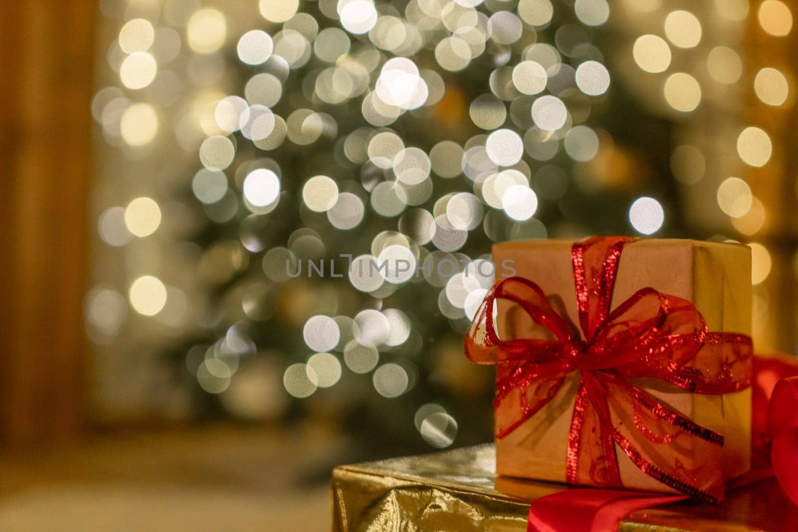 Christmas gift or present box, against magic bokeh background. Beautiful Christmas gift boxes with ribbon.