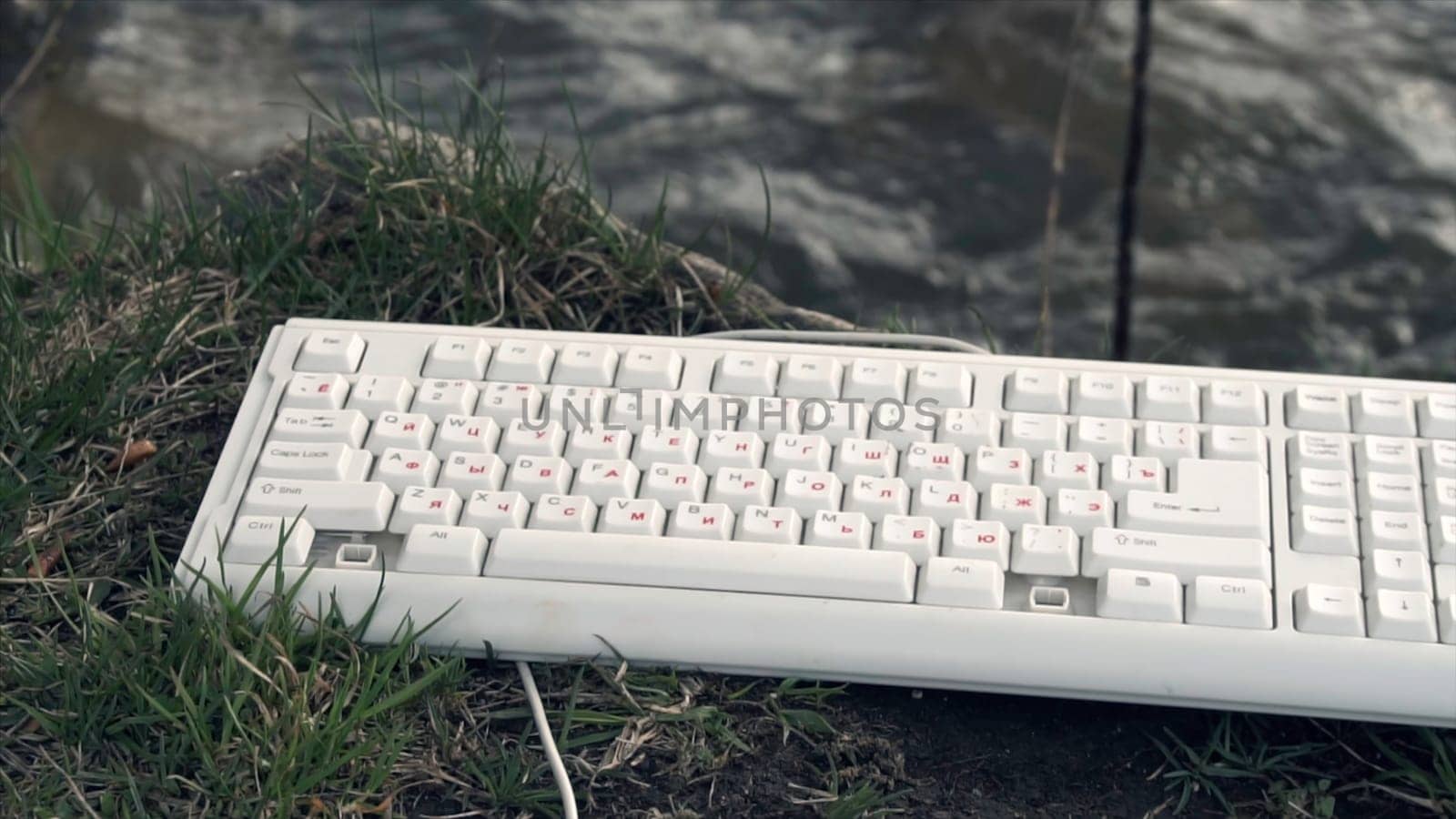 Broken Computer Keyboard. Broken computer keyboard in nature. The concept of technology's adverse impact on the world.