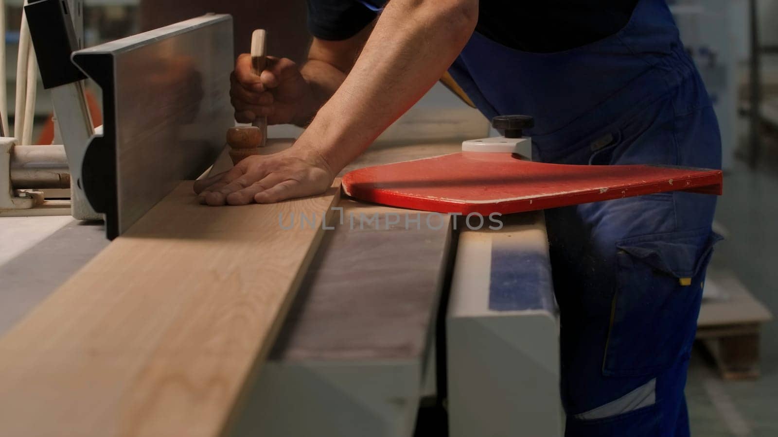 Industrial background with details of the workshop of the woodworking factory. Creative. Carpentry worker with a wooden board