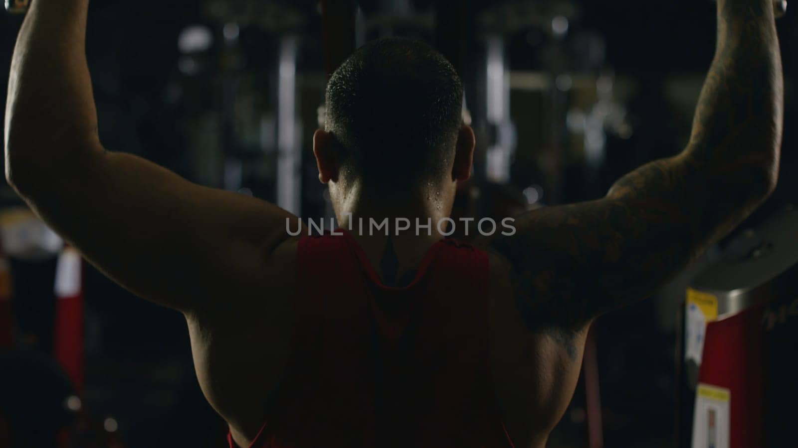 Sportsman athlete bodybuilder trains in the gym. Handsome muscular sports man in fitness club, top view. Fighter 4K