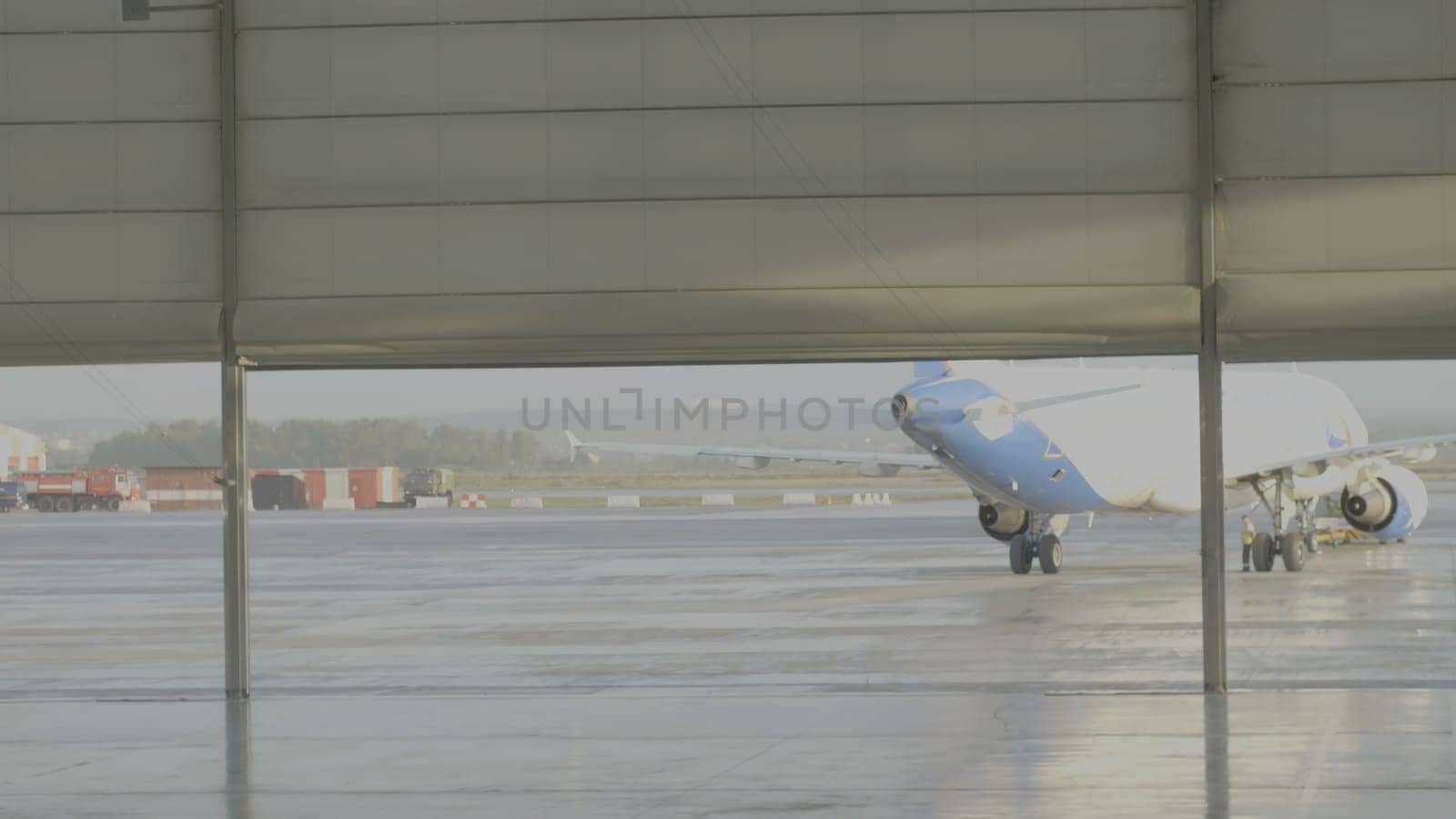 Yekaterinburg, Russia - August 2017: The airplane in the hangar, behind the whole plane and the gangway. Passenger jet airplane white color. Passenger plane in the hangar.