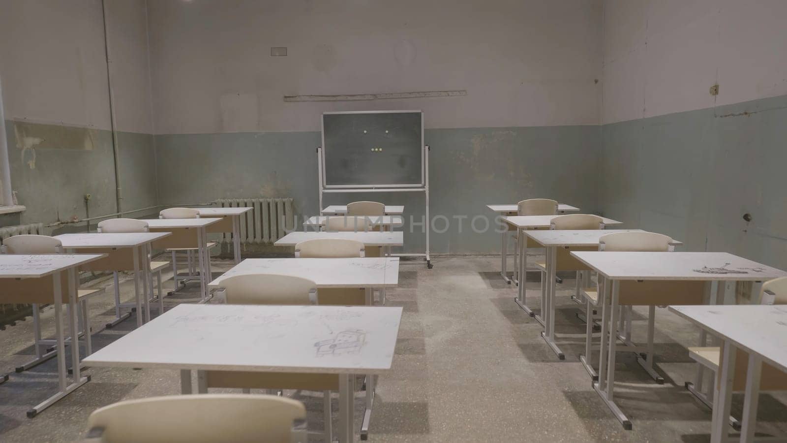 Empty classroom with wooden desks, white and green chalk boards in school. empty classroom. Abandoned School classroom with school desks and blackboard 4K