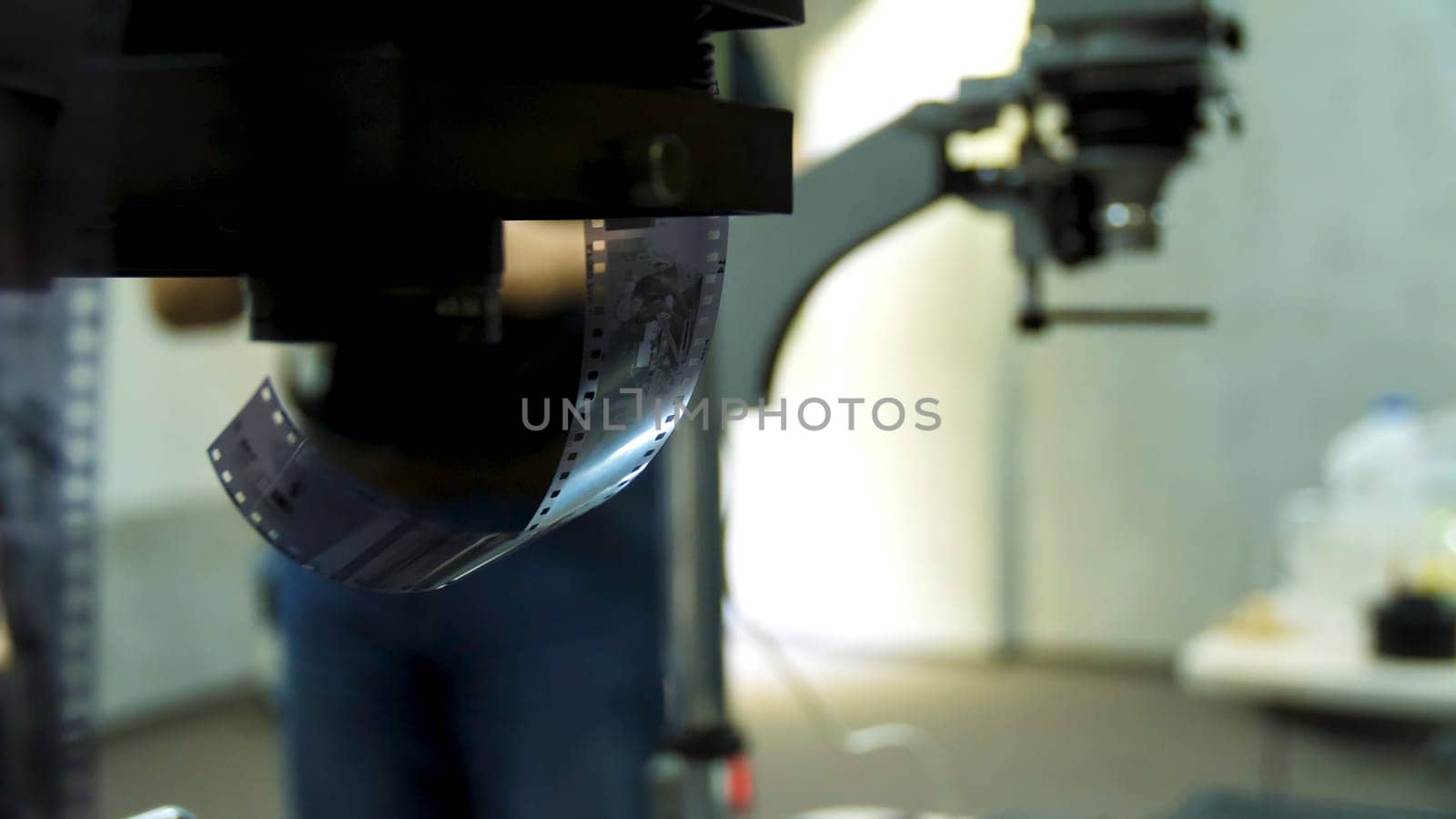 Film roll and device for film development on background. Old photo film rolls, cassette and retro camera on background. Thank of black and white film for develop 4K