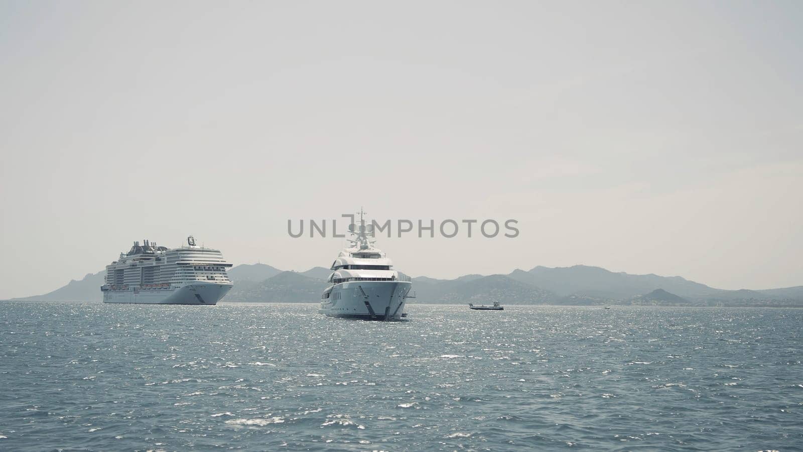 Luxury yacht cruising out at sea. Action. Aerial view of luxury yacht and cruise ship pm rippling water surface
