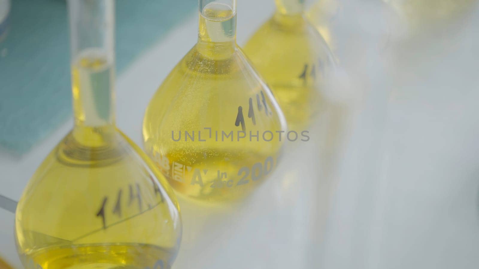 Glassware equipment in laboratory for science or chemical experiments. Action. Flasks filled with liquid substances at the lab