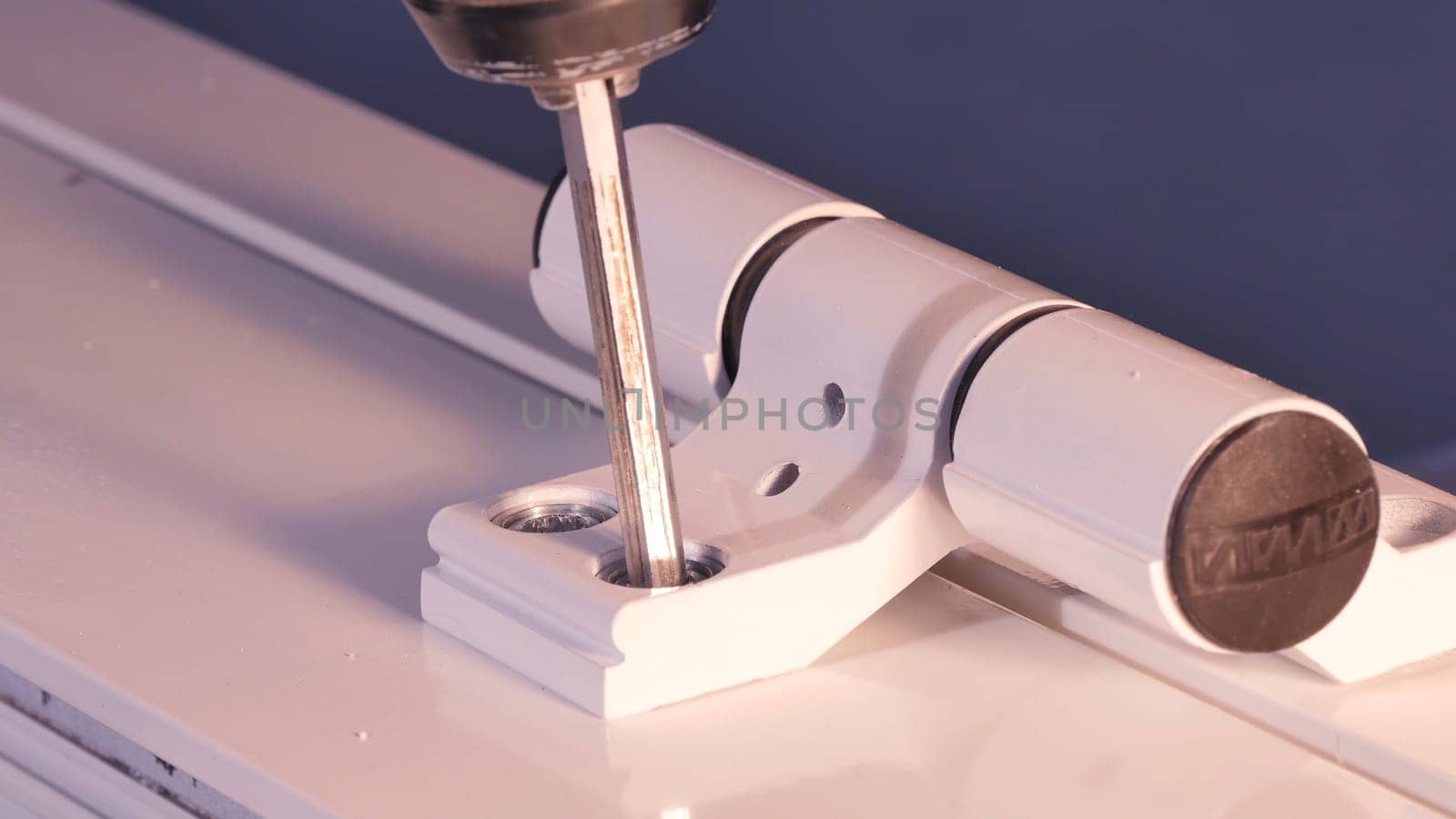 Installation Accessories For Plastic Pvc Windows. Screwdrivers or Drill. Male Hands Fasten Window Handle By Electric Screwdriver. Tempered float glass panels. Industry
