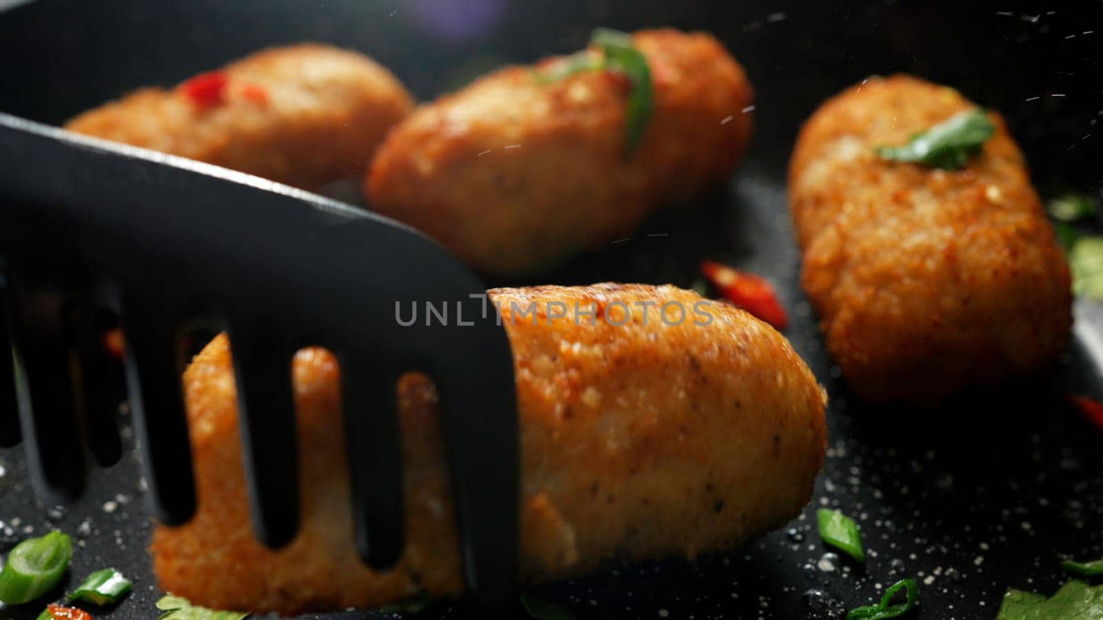 The cooking process. Stock footage. Frying meat cutlets with vegetables in hot pans. High quality 4k footage