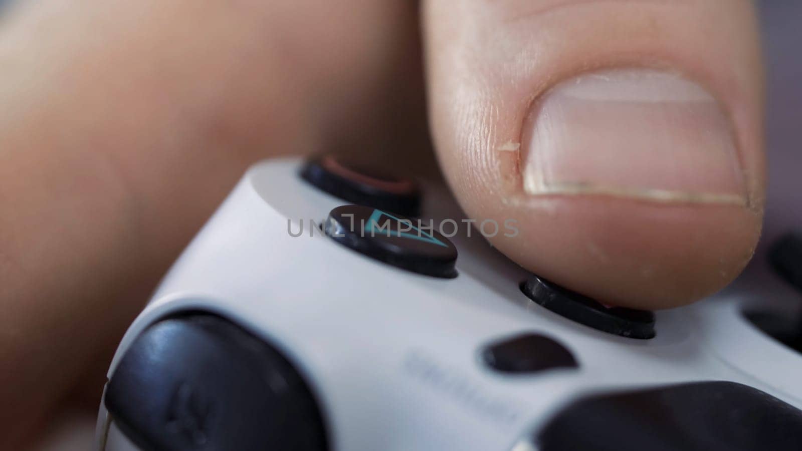 Close up of male hands holding a joystick controller while playing a video games at home - Young man having fun with games - Gaming, entertainment, technology concept