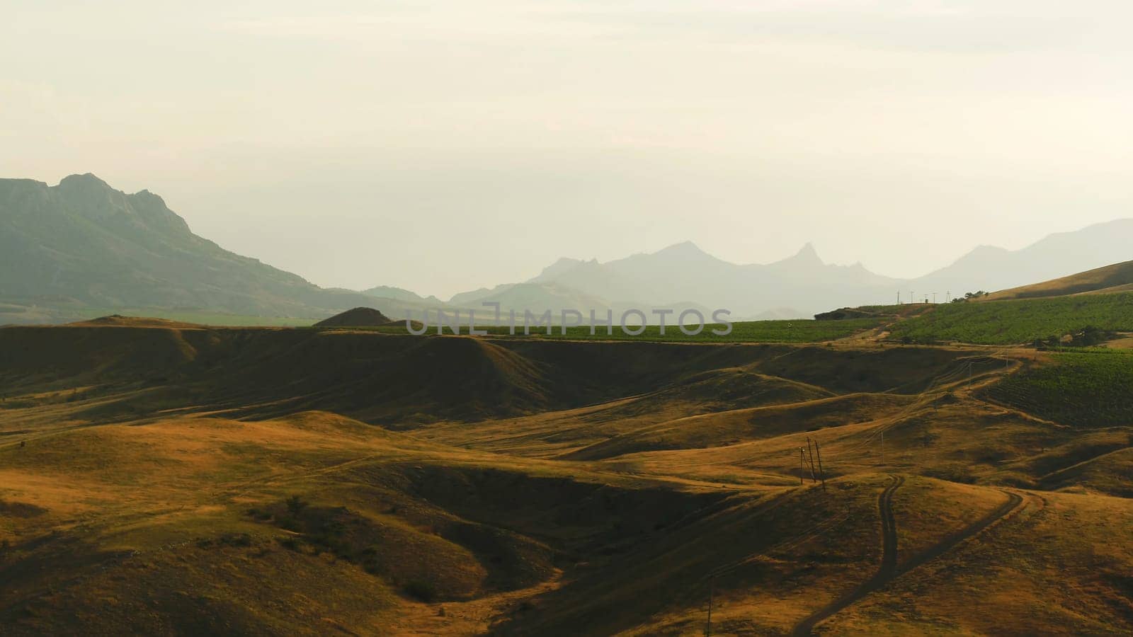 Top view of dry autumn meadows on the hills. Shot. Bright orange grass on a Sunny day.