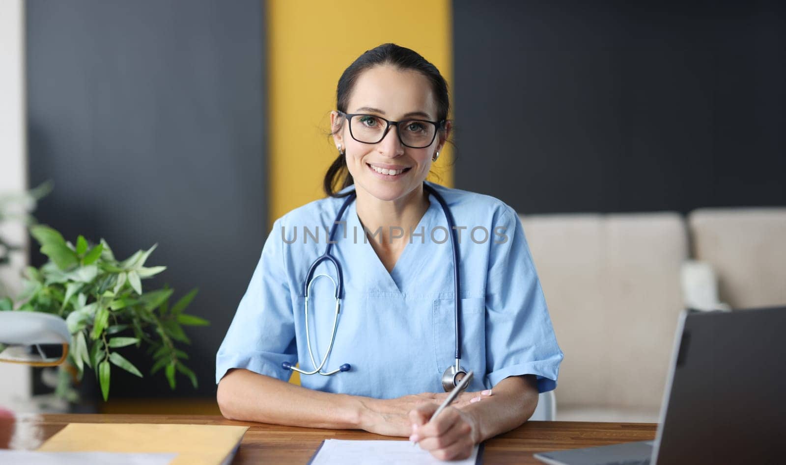 Woman doctor with glasses filling out medical history. Medical paperwork concept