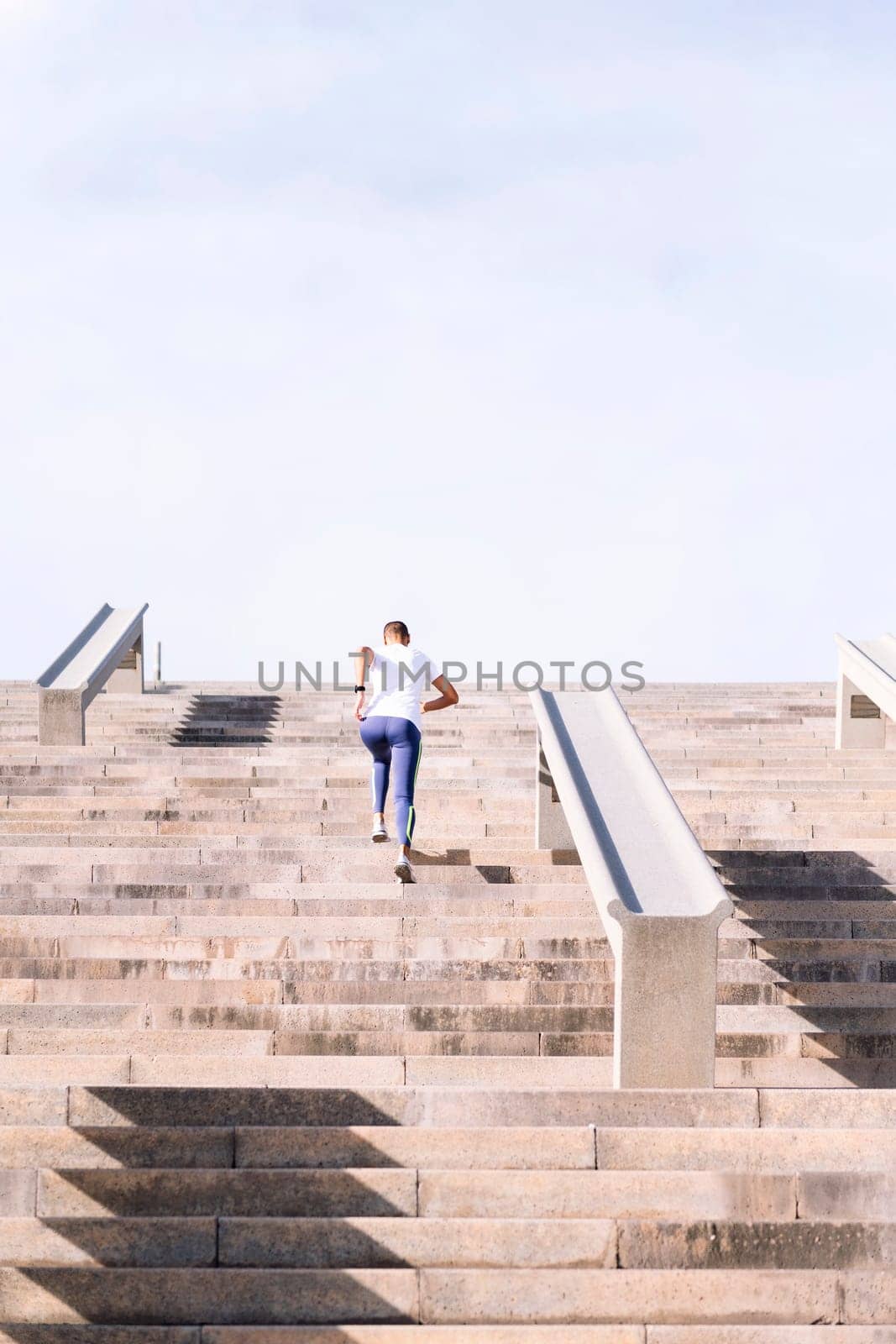 rear view of an unrecognizable sports woman training on stairs, concept of active and healthy lifestyle, copy space for text