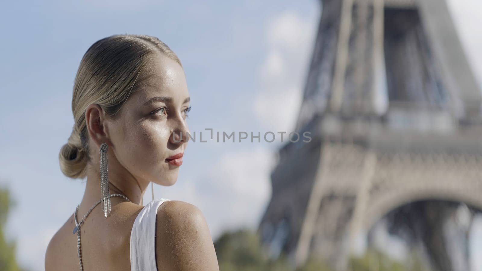 Gorgeous blonde bride on the background of the Effel tower in Paris, France. Action. Wedding day and an elegant woman