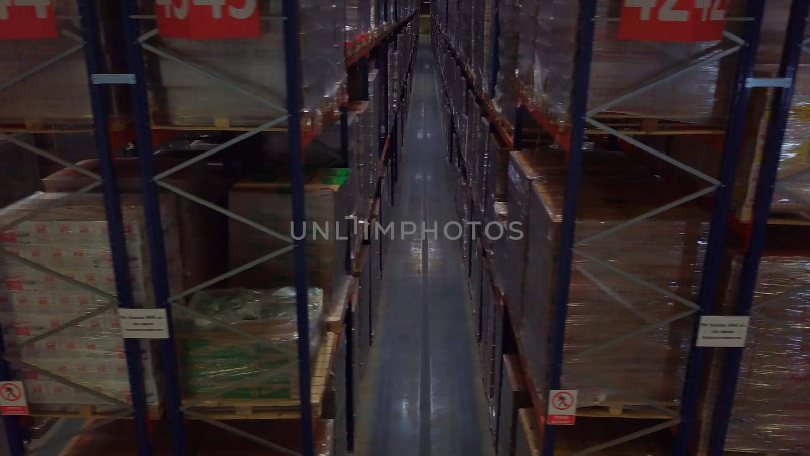 Warehouse with cardboard boxes inside on pallets racks, logistic center. Creative, Huge, large modern warehouse