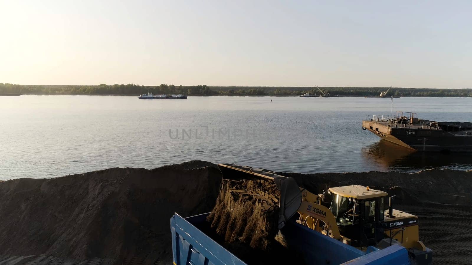Yekaterinburg, Russia - August, 2021:The construction process. Scene .Large trucks drive and build something on flat terrain next to the city. High quality 4k footage