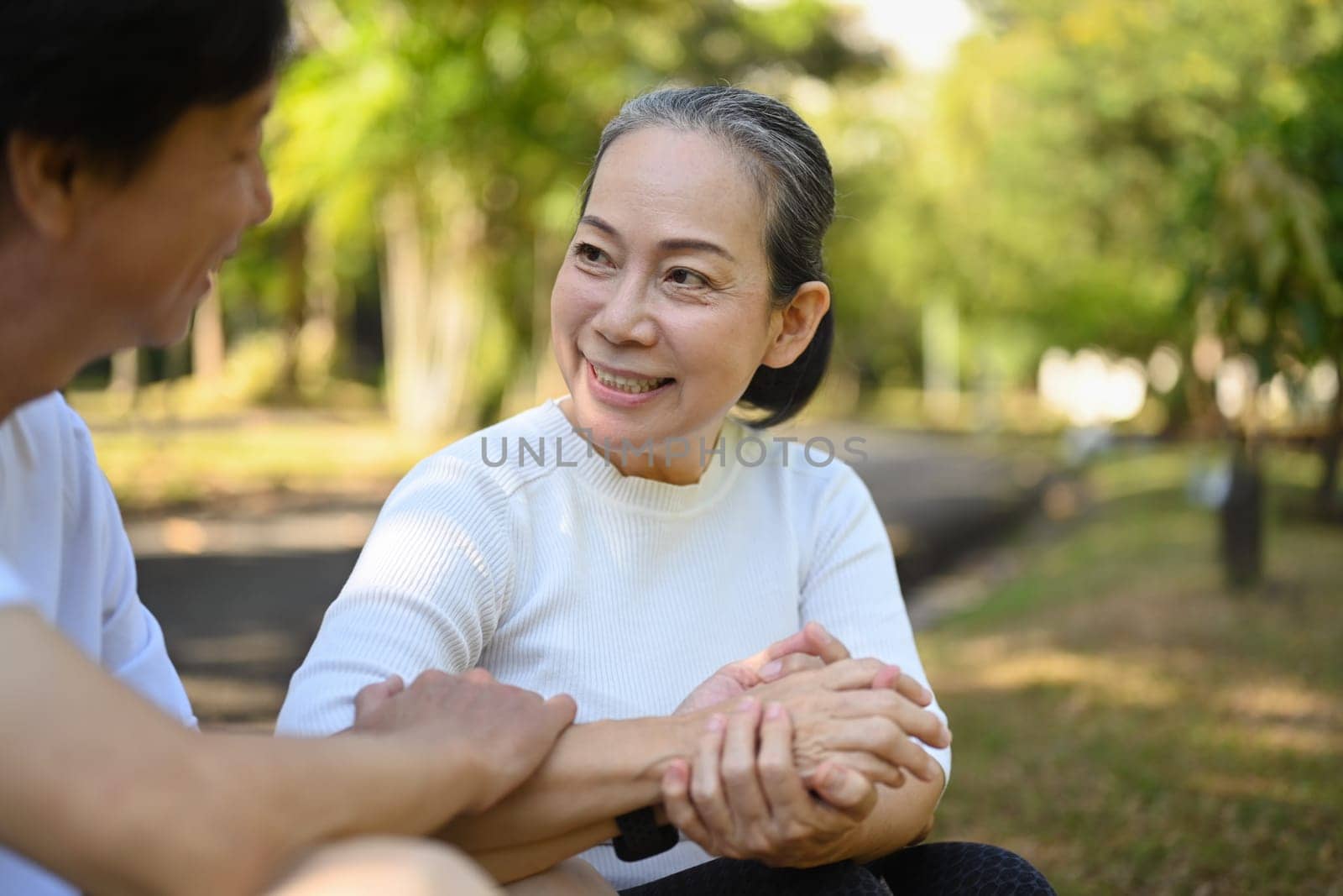 Caring middle age woman holding hand husband and looking with love. Retirement couple love and care concept