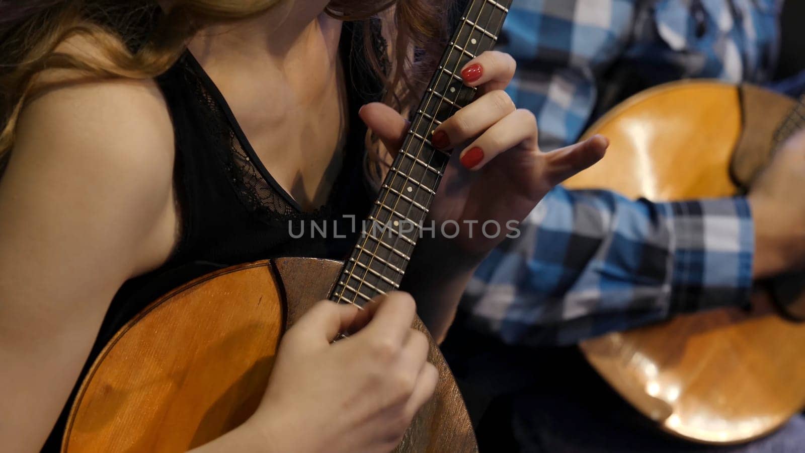Woman playing music with balalaika. Lifestyle concept. Russian instrument. Folk music russian ensemble - woman playing the balalaika.