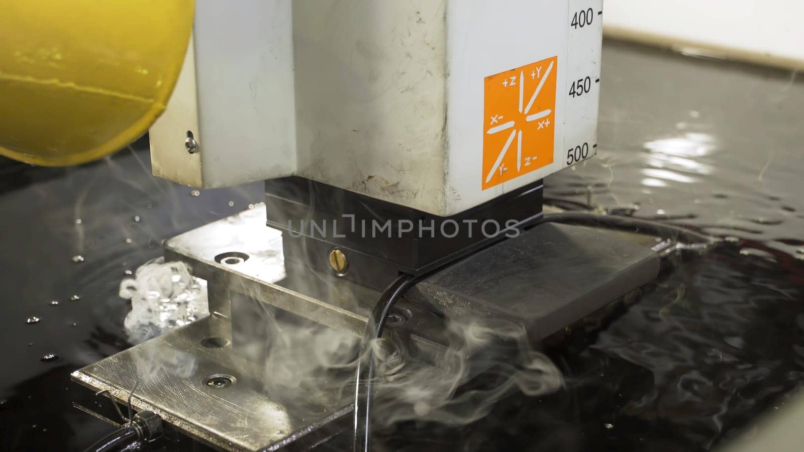 The abrasive water jet machine cutting the aluminium plate. The modern technology of sheet metal working process by high pressure water jet machine.