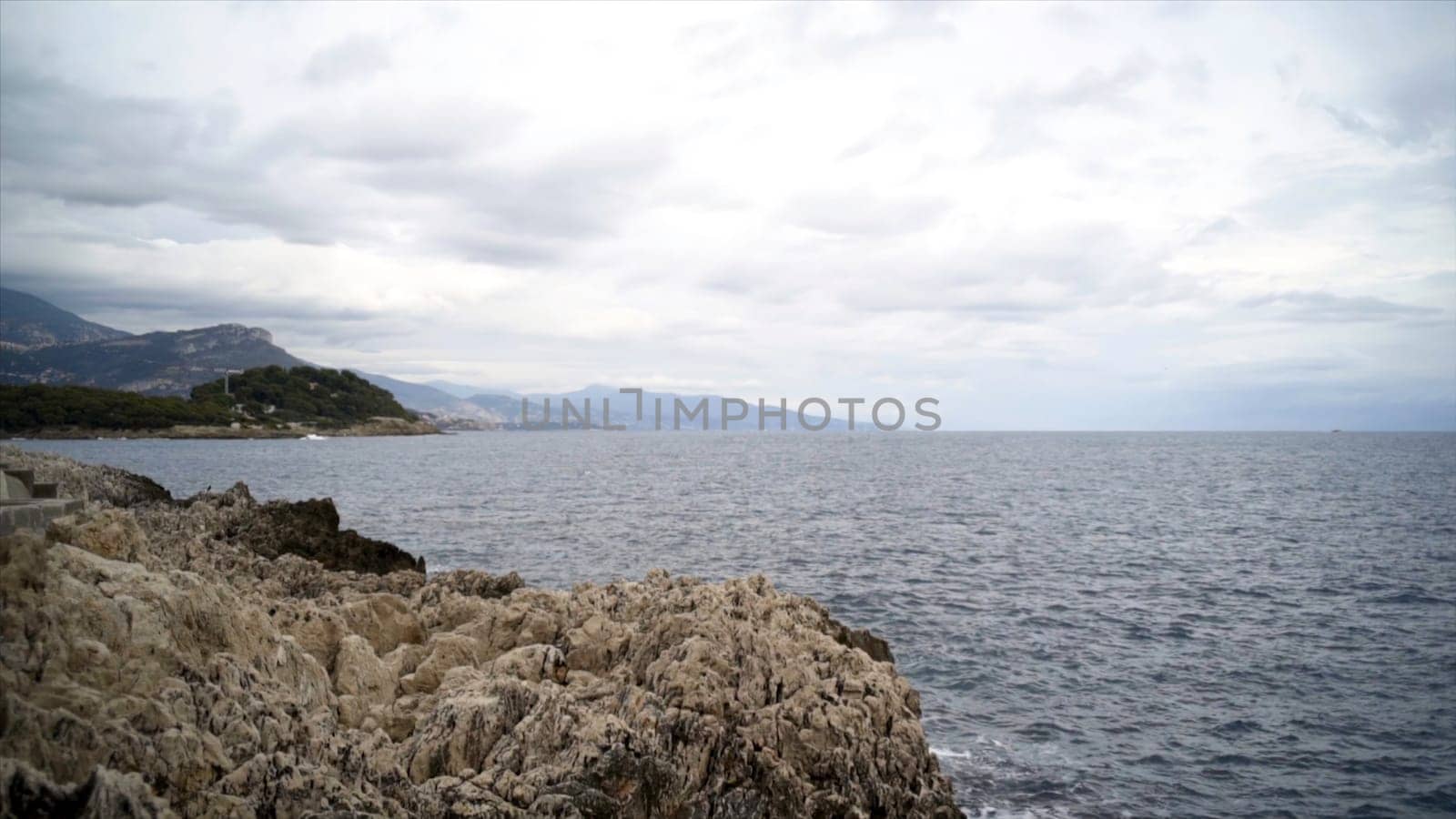 Panoramic view of nice colorful huge cliff and sea. Action. View of the rocks and waves of the sea.