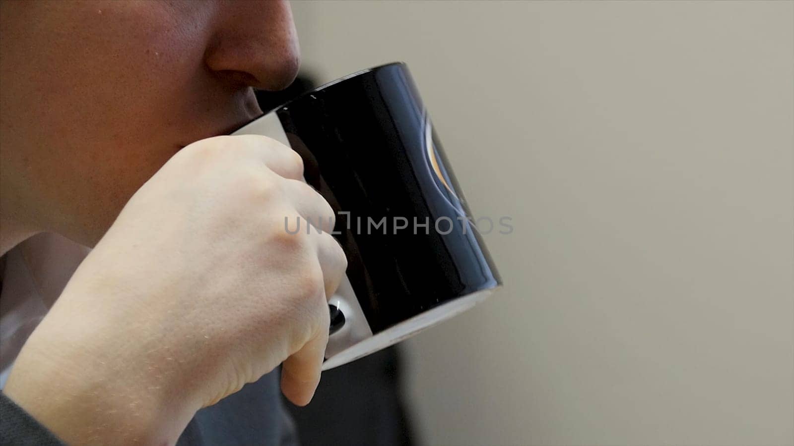Businessman having a coffee break. close up business man with coffee cup. Close up male arm holding plastic money. He drinking cup of coffee. Break concept.