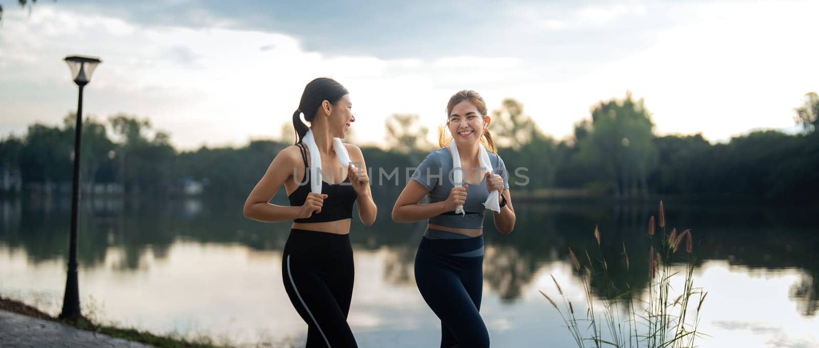 Healthy and active lifestyle, sport concept. Attractive ecstatic young sportswoman, smiling joyfully as jogging, sprinter run in park by nateemee