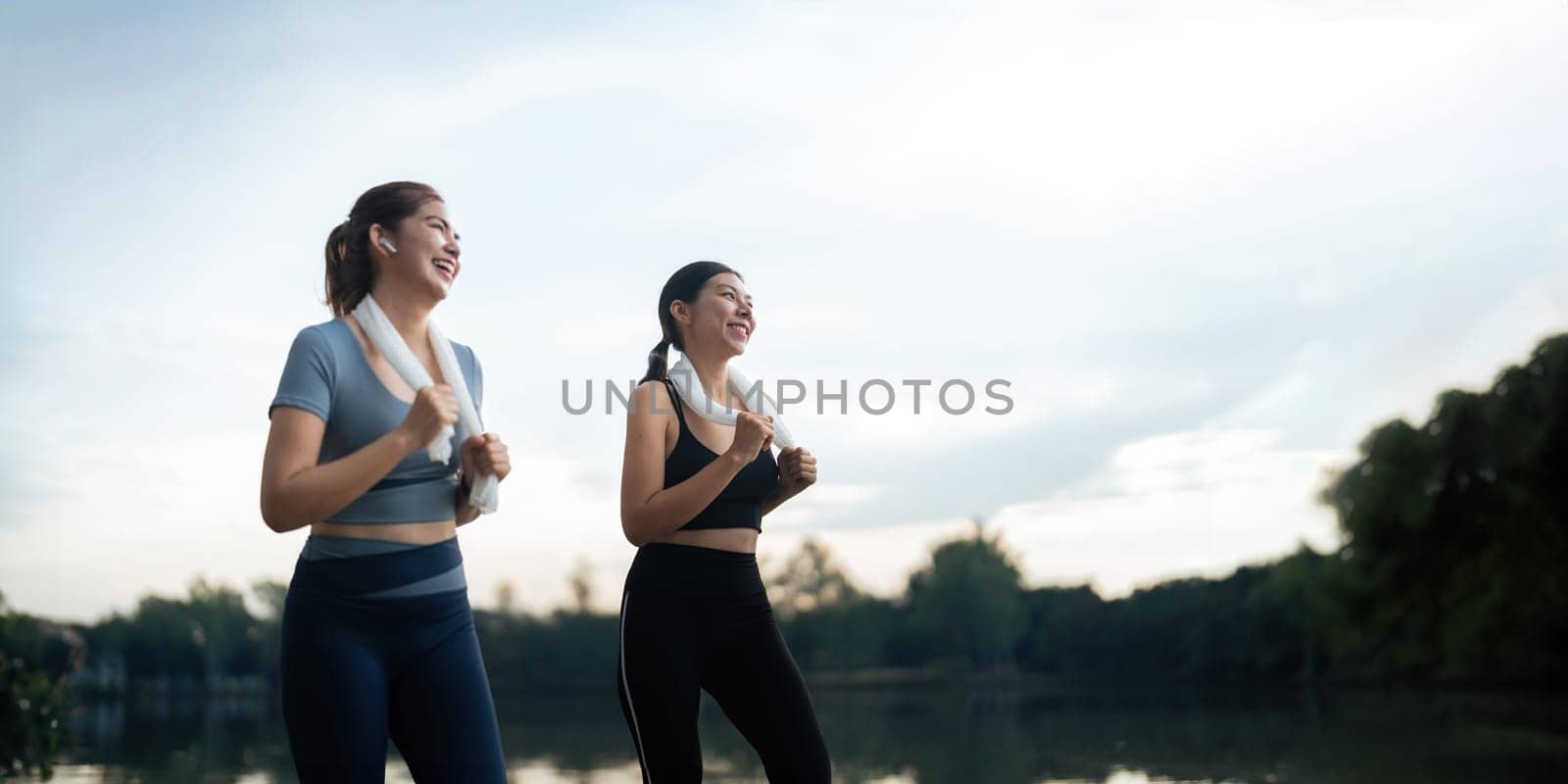 Healthy and active lifestyle, sport concept. Attractive ecstatic young sportswoman, smiling joyfully as jogging, sprinter run in park by nateemee