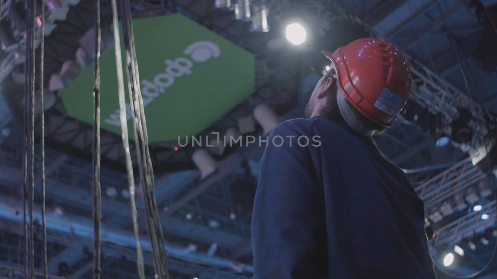 Worker man watching some details on construction. Man in the helmet watching the work.