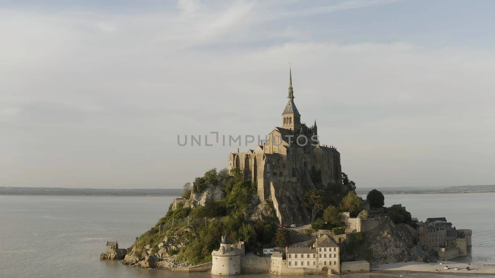 Beautiful Mont Saint Michel cathedral located on the island, Normandy, Northern France, Europe. Panoramic view of famous historic tidal island with stunning castle.