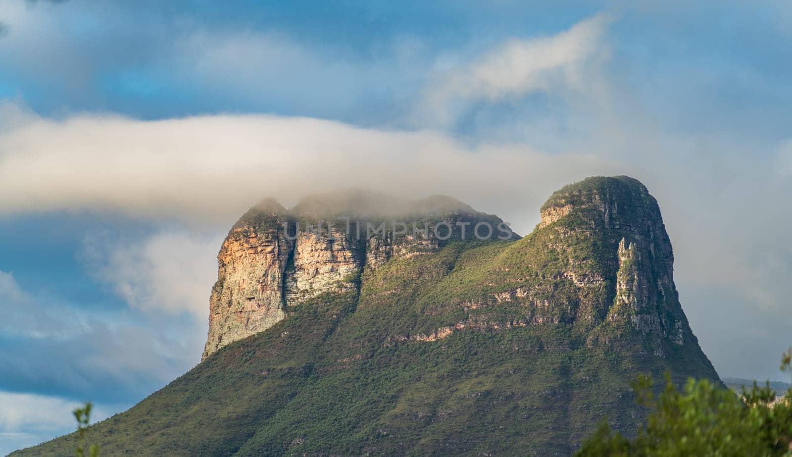 Beautiful rock formation emerges under a cloudy sky in Chapada Diamantina, showcasing natural beauty.