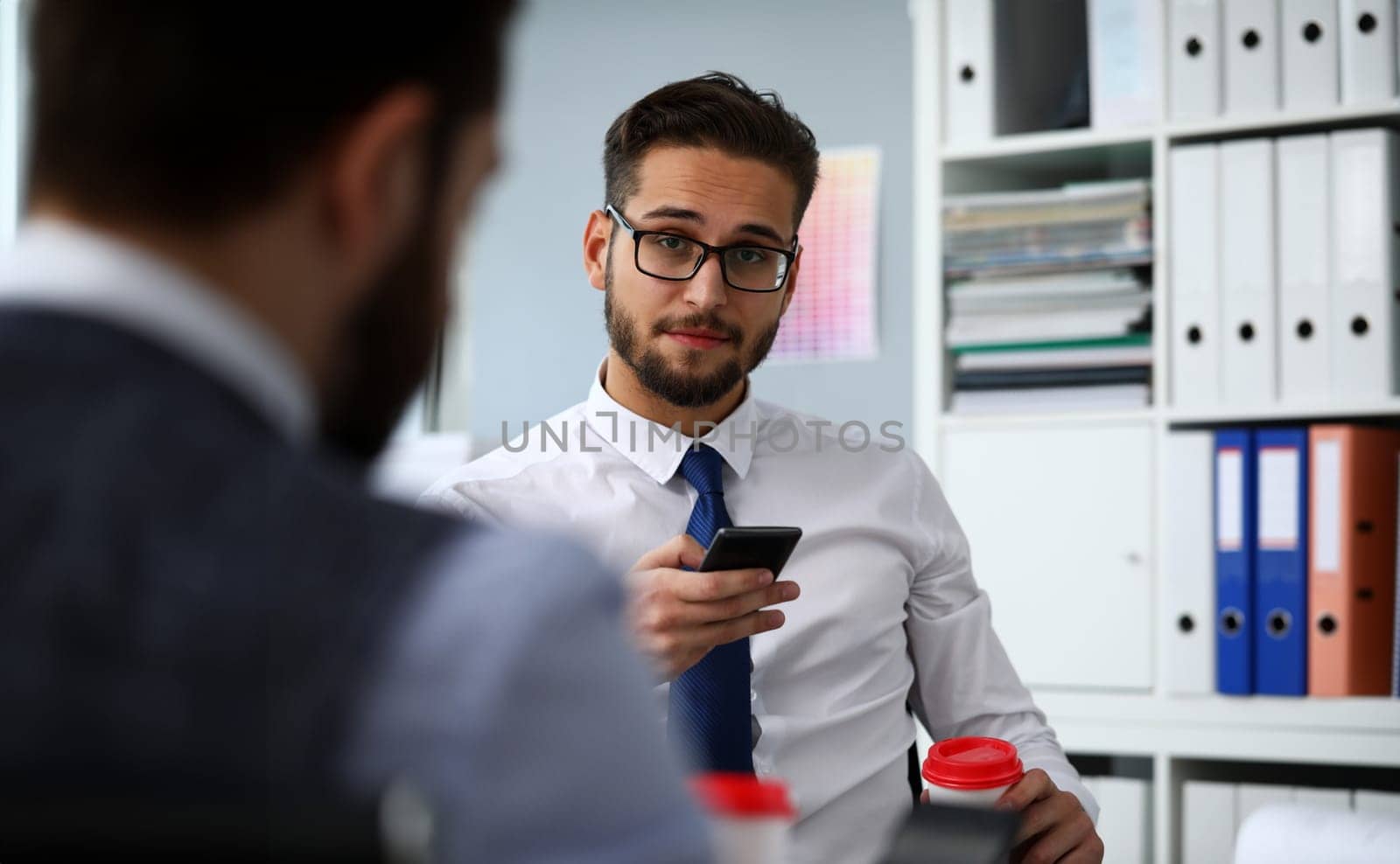 Businessman hold in arms paper cup of hot fresh coffee and cellphone at office workplace portrait. Read news mania send sms chat addict use electronic bank modern idea job share blog tweet web search