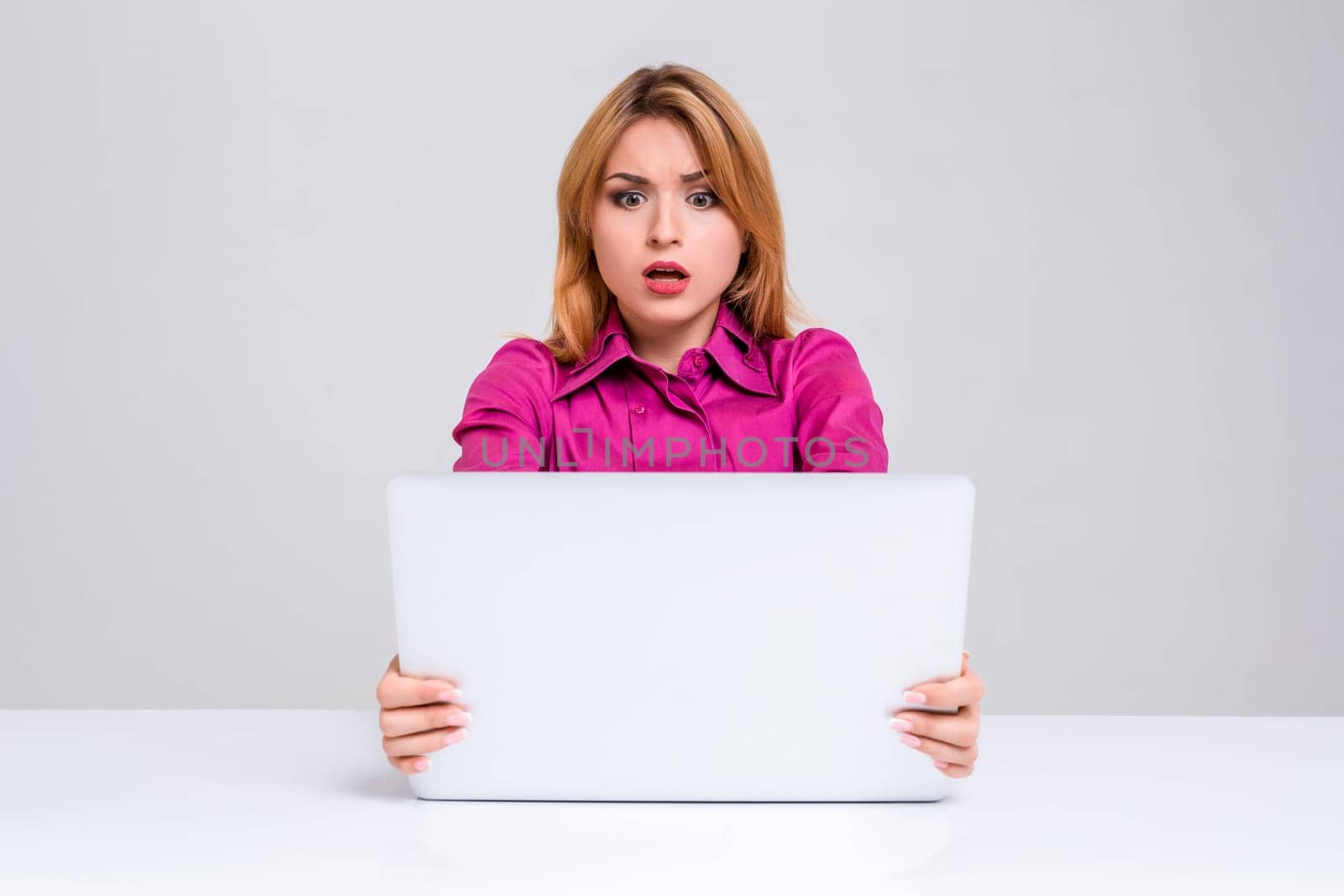 young woman sitting in the table and using laptop by nazarovsergey