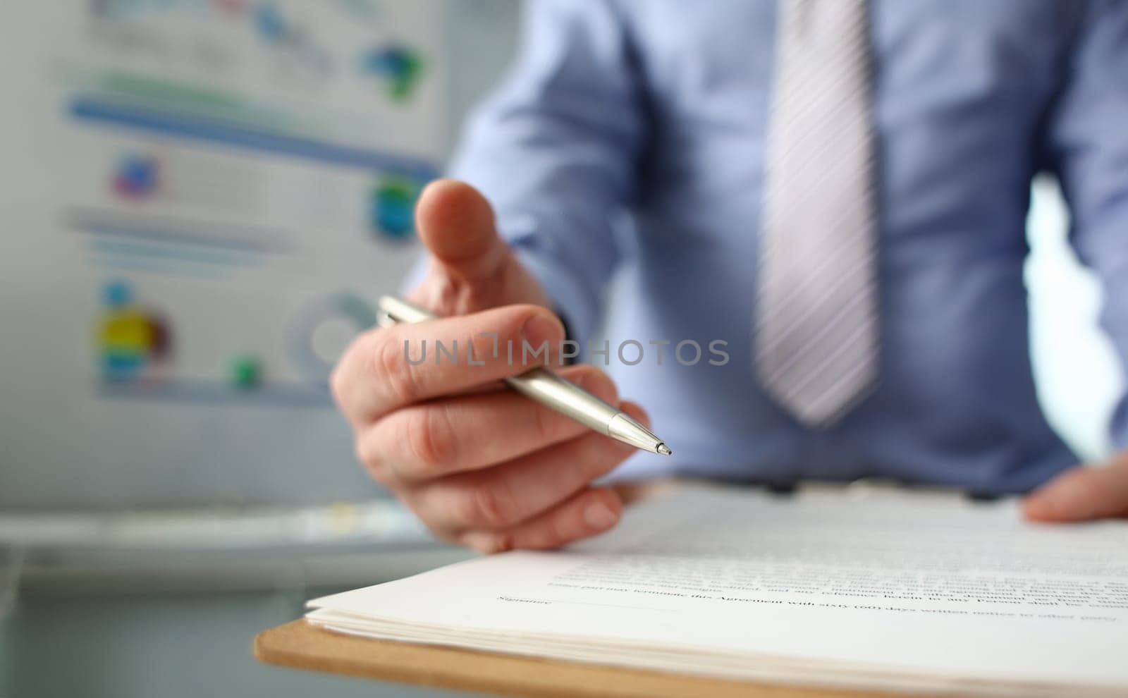 Male arm in suit offer contract form on clipboard pad and silver pen to sign closeup. Strike a bargain for profit white collar motivation union decision corporate sale insurance agent concept