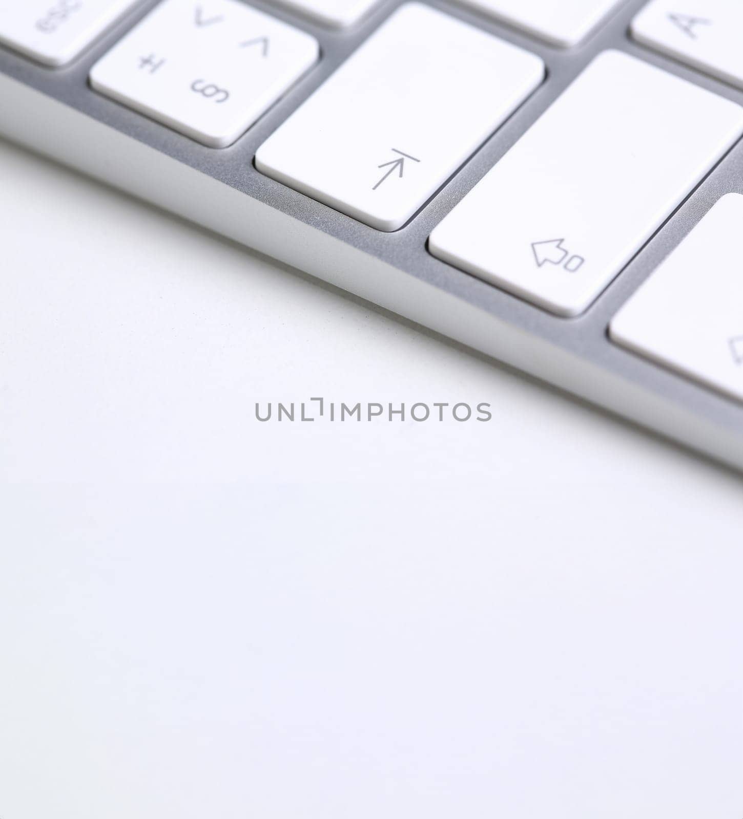 Silver keyboard with white key push button background closeup