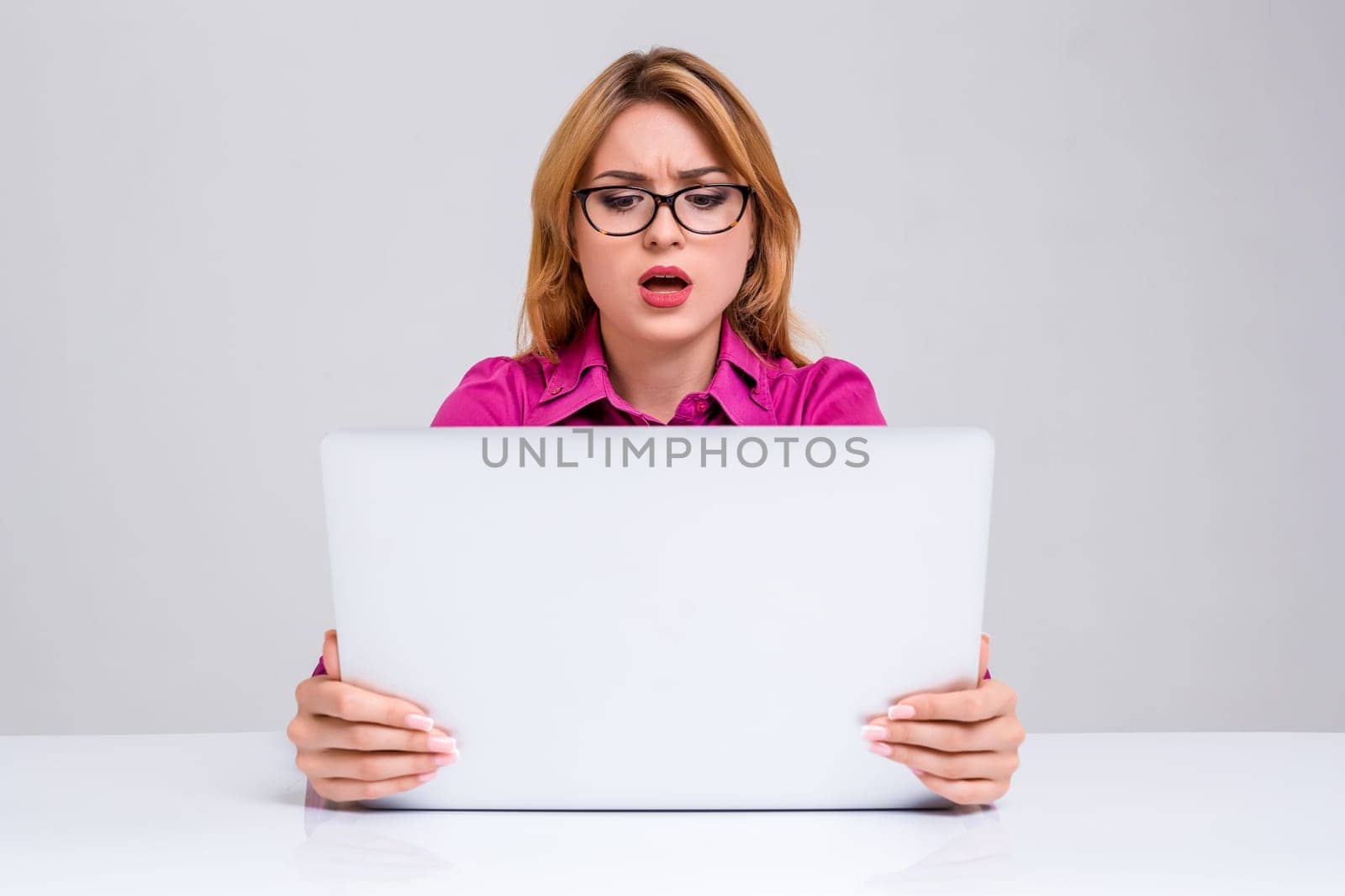 Young businesswoman working at laptop computer. she was surprised, prints and looking at monitor