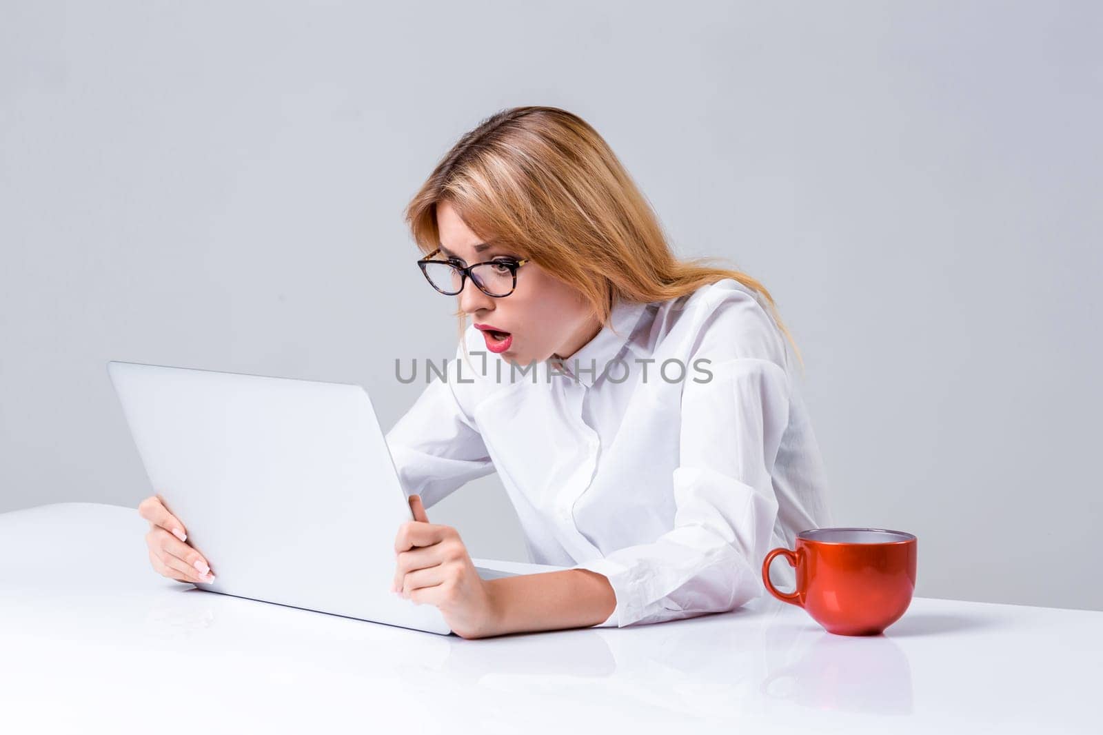 young woman sitting in the table and using laptop by nazarovsergey