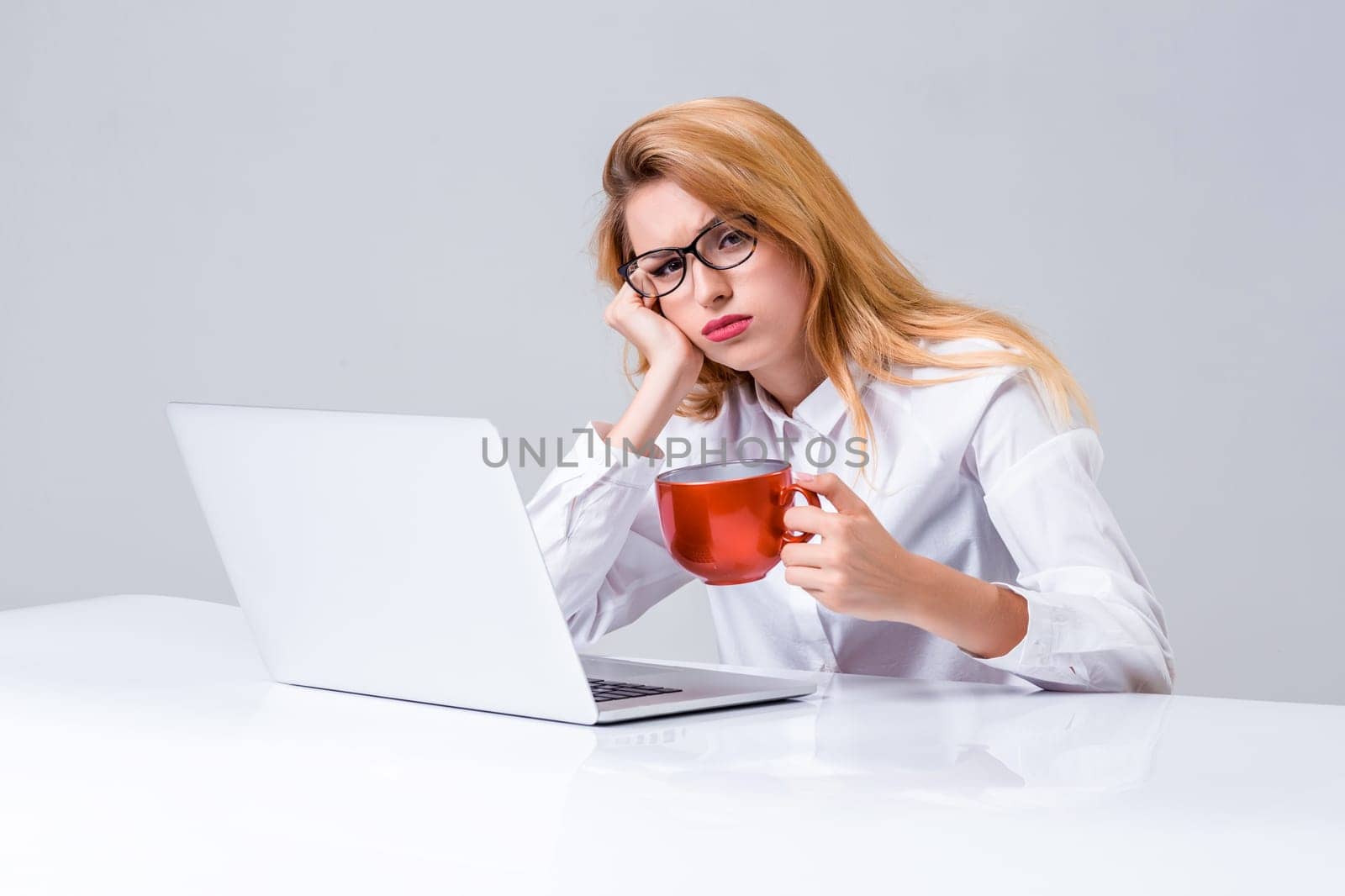 Young businesswoman working at laptop computer. she was tired, prints and looking at monitor