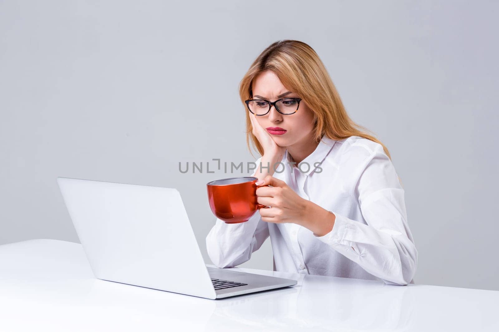 Young businesswoman working at laptop computer. she was tired, prints and looking at monitor